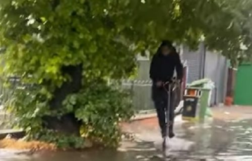 Očekivao je da može tako do posla: Momak u POPLAVLJENOJ ulici pao sa skutera (VIDEO)